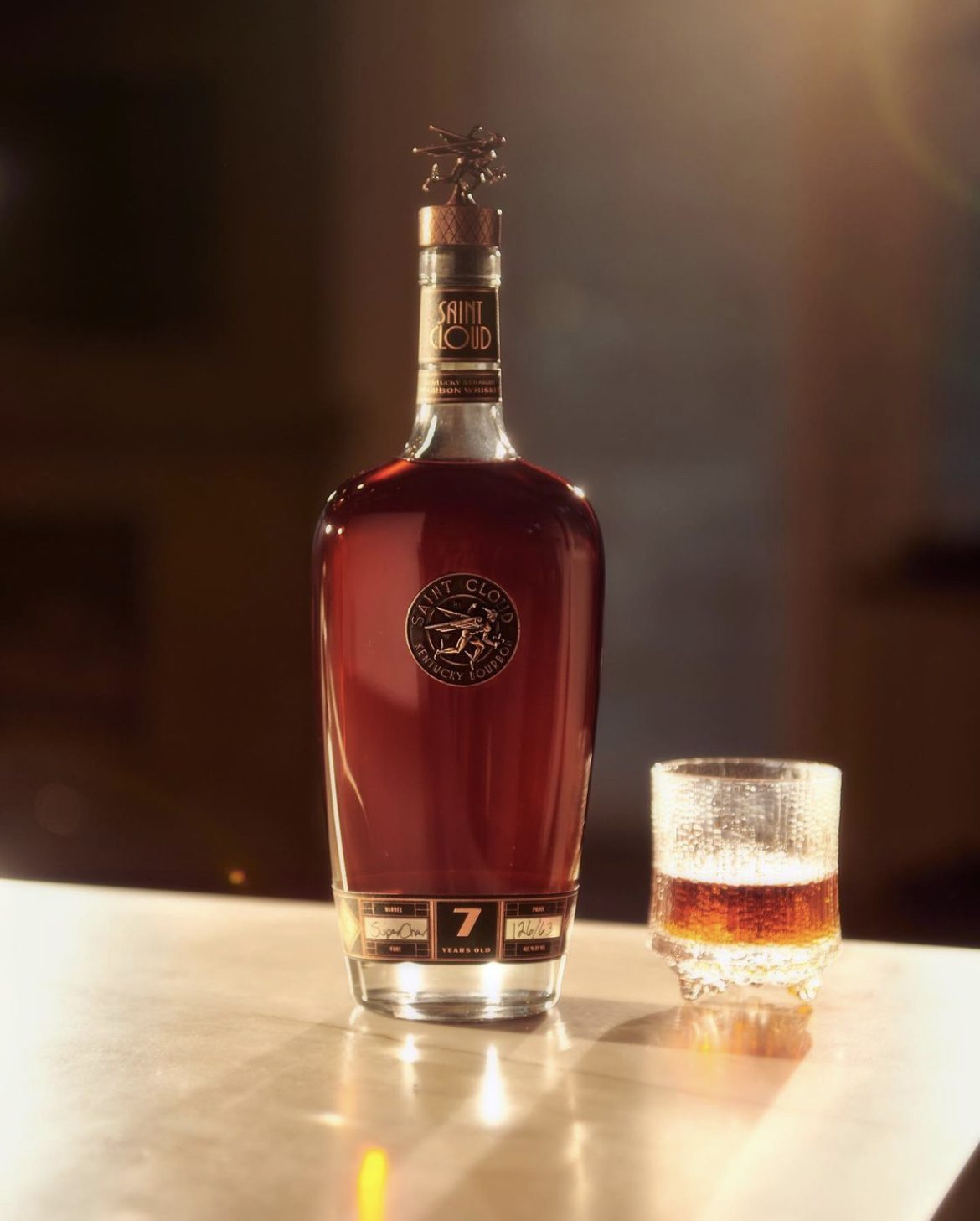 A bottle of Saint Cloud 8 Year and a rocks glass on a table